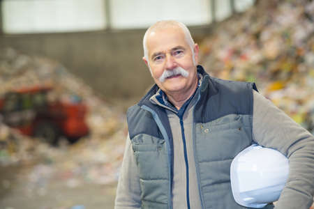 senior engineer standing in recycling plantの写真素材