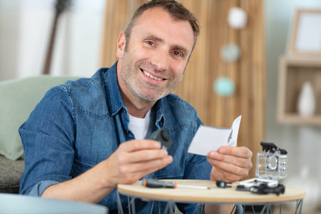 mature man happily doing diy at home