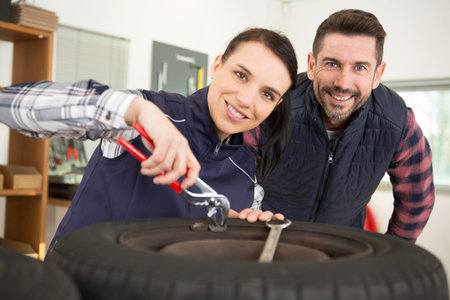 female mechanic repairing a car in a garage