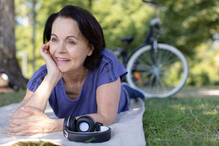 happy positive old lady relaxing in park