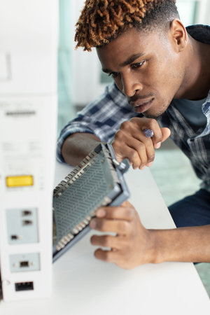 hardware repairman repairing broken printer fax machine