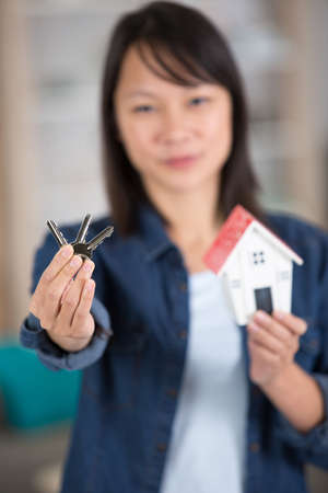 young businesswoman real estate agent with hose model and keysの写真素材