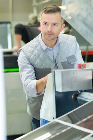 male worker on belt conveyorの写真素材