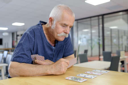 senior playing cards in the retirement houseの写真素材