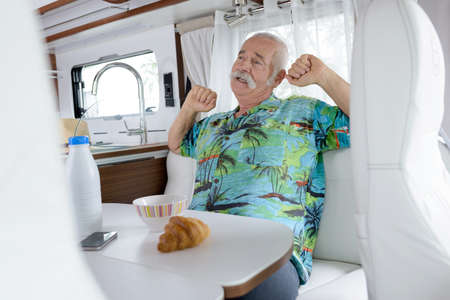 senior in his van during holidaysの写真素材