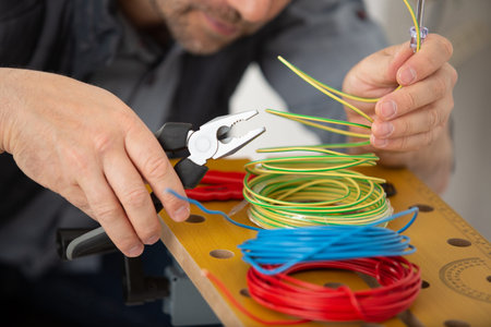 hands cutting cables with pliersの写真素材