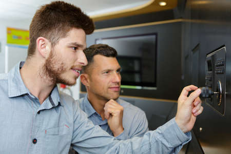 two technicians working in a workshopの写真素材