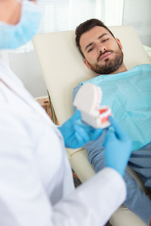 shot of a handsome man in a dental chair