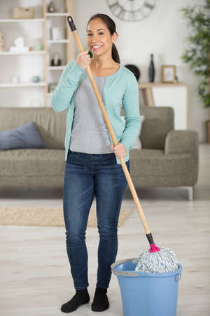 portrait of a woman with a mop and bucketの写真素材