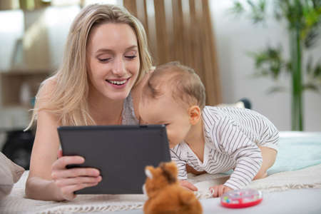 mother and baby using digital tabletの写真素材