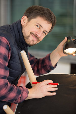 happy man using tools to fix a chair