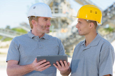 construction workers with tablet outdoors