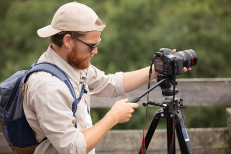 a concentrated videographer documenting outdoors