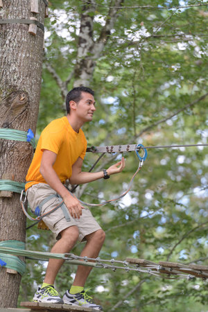 nervous man preparing to descend zip wireの写真素材