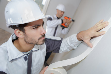 painter using masking tape before paintingの写真素材