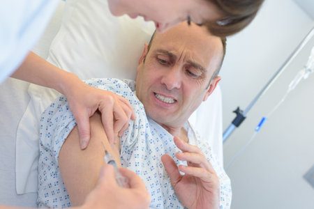 a man is scared of injectionの写真素材