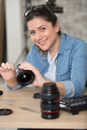 woman cleaning a camera lensの写真素材