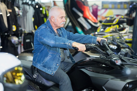 portrait of senior man steering motorcycle