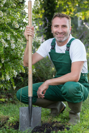 handsome man digging with a shovelの写真素材