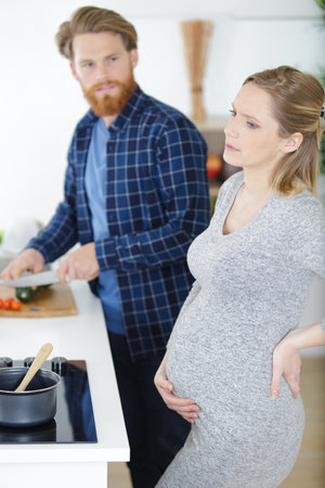 young pregnant woman suffering at homeの写真素材