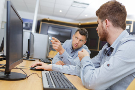 portrait of workers next to pc