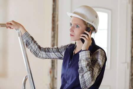 woman contractor worker on you phoneの写真素材