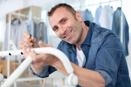 a man assembling new furnitureの写真素材