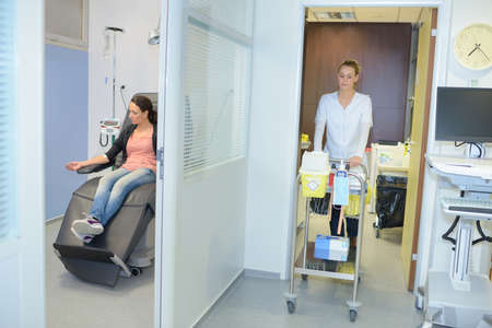 patient and nurse on trolleys in hospitalの写真素材