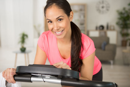 woman setting up her exercise machine for workout