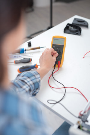 woman with a tester and a printed circuit board