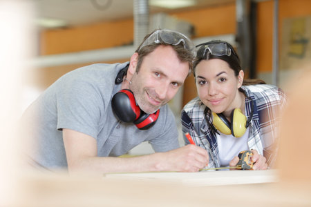 young working as a team doing diy renovationsの写真素材