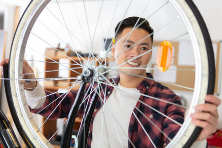 happy man bicycle mechanic repairing bicycles
