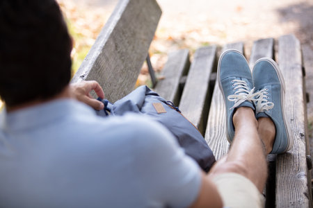 young man sitting on a benchの写真素材