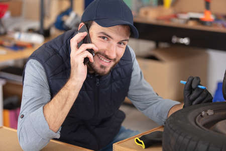 construction worker with contemporary mobile phoneの写真素材
