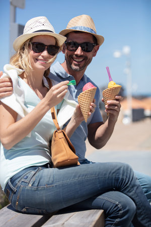 happy couple having date and eating ice cream