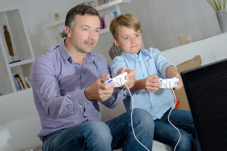 Father and son engrossed in a computer game