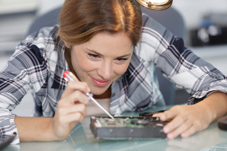 woman repairing an electronic device
