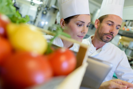 portrait of two adult chefs in a kitchen
