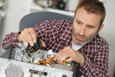 a man fixing electronic pc