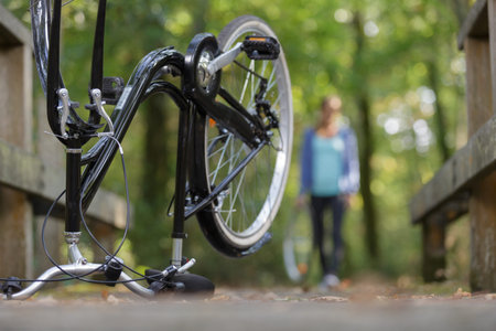 woman with wheel returning to her upside down bicycle
