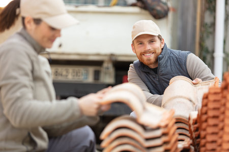 construction workers with tiles builders