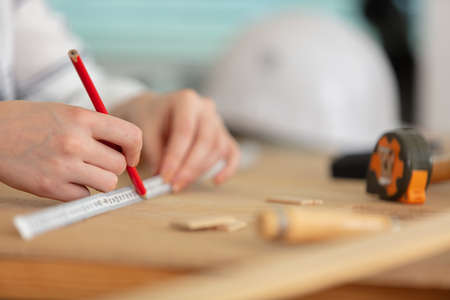 hands drawing line with pencil and scale rulerの写真素材