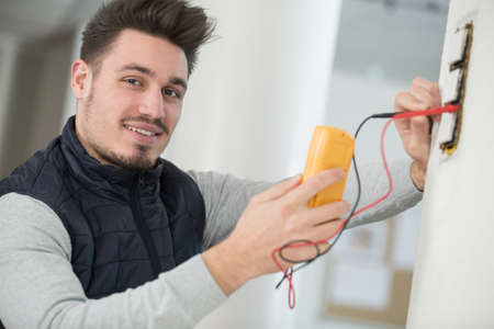 an electrician checking socket voltageの写真素材