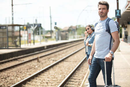people about to board a train at the stationの写真素材