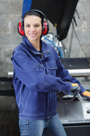 portrait of woman factory worker looking at cameraの写真素材