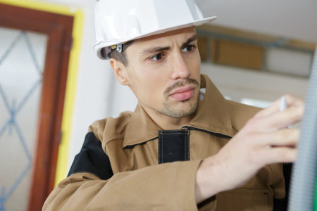 builder checking work with spirit level