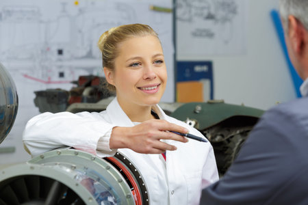 engineer woman talking to manager in industry factory