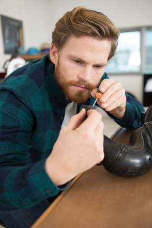 male worker repairing car exhaust pipe