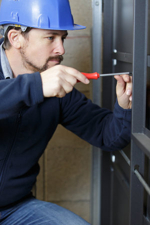 close view of handyman using screwdriverの写真素材