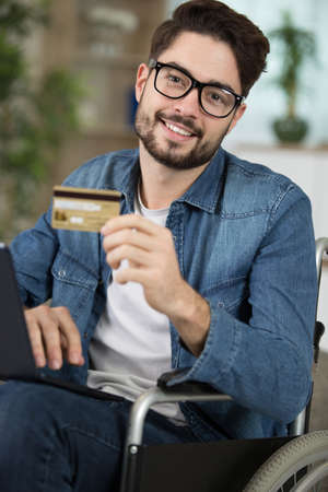 disabled man on wheelchair during online shoppingの写真素材